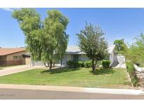 Ranch style home with mature landscaping and a detached garage at 4936 E Coronado Rd, Phoenix, AZ 85008