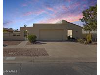 Single-story home with a large garage and desert landscaping at 1500 N Markdale -- # 64, Mesa, AZ 85201