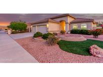 Landscaped front yard with artificial turf and stone accents at 16513 W Windsor Ave, Goodyear, AZ 85395