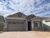 Craftsman style home with a neutral color palette and a two-car garage at 20006 S 231St St, Queen Creek, AZ 85142