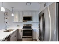 Modern kitchen with stainless steel appliances and white cabinets at 145 N 74Th St # 241, Mesa, AZ 85207