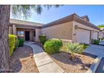 Attractive desert landscaping enhances the curb appeal of this two-car garage home at 846 N Pueblo Dr # 111, Casa Grande, AZ 85122