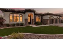 Evening view of the home exterior with attractive landscaping and lighting at 2717 W Nighthawk Way, Phoenix, AZ 85045
