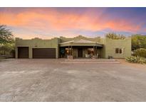 Desert landscape home with a large driveway and casita at 33120 N 67Th St, Cave Creek, AZ 85331