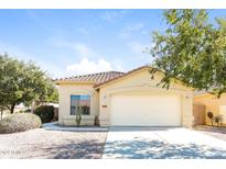 Single-story home with attached garage and desert landscaping at 34831 N Mashona Trl, San Tan Valley, AZ 85143