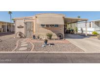 Mobile home with decorative landscaping and covered carport at 2650 W Union Hills Dr # 184, Phoenix, AZ 85027