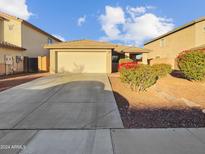 Charming single story home with attached two car garage and landscaping at 6556 S 258Th Dr, Buckeye, AZ 85326