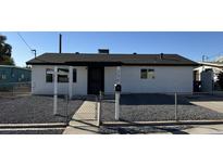 Newly renovated single story home with a gravel front yard and chain link fence at 236 S 2Nd St, Avondale, AZ 85323