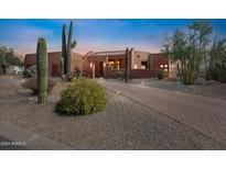 Beautiful desert landscape with a stucco home and brick driveway at 23461 N 80Th Way, Scottsdale, AZ 85255