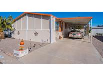 Mobile home exterior with covered carport and landscaping at 201 S Greenfield Rd # 176, Mesa, AZ 85206