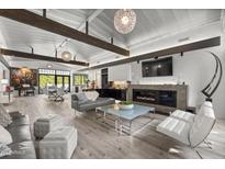 Open living area with fireplace, hardwood floors, and modern furniture at 8614 E Berridge Ln, Scottsdale, AZ 85250