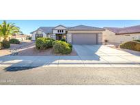 Single story home with attached two car garage and desert landscaping at 18483 N Deer Grass Ct, Surprise, AZ 85374
