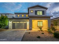 Two-story house with gray exterior and landscaped yard at 22689 E Bonanza Way, Queen Creek, AZ 85142