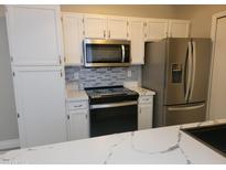 Kitchen with stainless steel appliances and white cabinets at 1942 S Emerson -- # 131, Mesa, AZ 85210