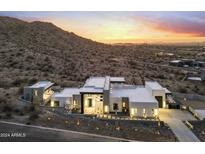 Stunning aerial view of a modern home nestled in the desert landscape at 9520 S Krista W Dr, Goodyear, AZ 85338