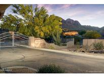 Gated entrance to community with mountain views at sunset at 10169 E Dinosaur Ridge Rd, Gold Canyon, AZ 85118