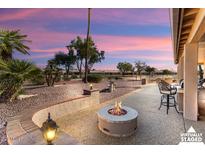 Covered patio features a fire pit and outdoor seating area at 3507 N Snead Dr, Goodyear, AZ 85395