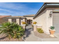 Front entry with walkway, gate, and desert landscaping at 26984 W Yukon Dr, Buckeye, AZ 85396