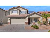 Two-story house with beige exterior, solar panels, and landscaped yard at 20722 N 38Th St, Phoenix, AZ 85050