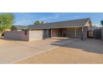 Single-story home with carport and modern brick facade at 3033 E Sierra St, Phoenix, AZ 85028