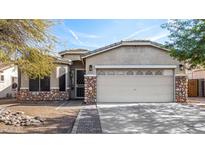 Front view of a charming house with stone accents and a two-car garage at 6613 S 16Th Dr, Phoenix, AZ 85041