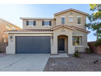 Two-story house with a gray double garage door at 38318 N La Grange Ln, San Tan Valley, AZ 85140