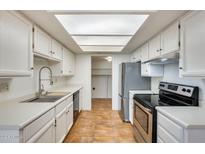 Bright kitchen features stainless steel appliances and ample counter space at 222 W Brown Rd # 117, Mesa, AZ 85201