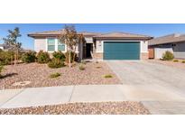 Single-story home with teal garage door and landscaped front yard at 1170 E Meadowridge Dr, Casa Grande, AZ 85122