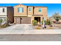Two-story house with a brown facade, two-car garage, and landscaping at 12526 W Palmaire Ave, Glendale, AZ 85307