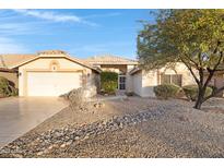 Single-story home with a two-car garage and desert landscaping at 19039 N 90Th Ln, Peoria, AZ 85382