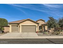 Beautiful desert landscape surrounds this single-story home with a three-car garage at 27046 W Yukon Dr, Buckeye, AZ 85396