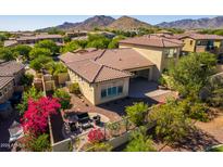 Aerial view of backyard with patio, seating area and bougainvillea at 3525 N Carlton St, Buckeye, AZ 85396