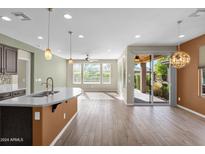 Open floor plan showcasing a modern kitchen island and Gathering room with access to a patio at 731 E Verde Blvd, Queen Creek, AZ 85140