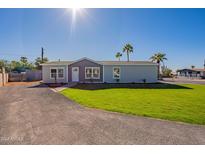 Single-story home with gray exterior, landscaping, and a grassy yard at 249 N 89Th St, Mesa, AZ 85207
