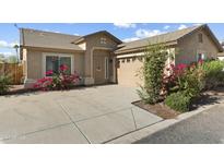 Single-story home with a two-car garage and nicely landscaped front yard at 3324 E Tierra Buena Ln, Phoenix, AZ 85032