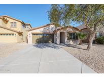 Single-story home with a two-car garage and landscaped front yard at 41208 W Bravo Dr, Maricopa, AZ 85138