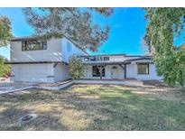 White two-story house with attached garage and landscaped lawn at 6312 N 13Th St, Phoenix, AZ 85014