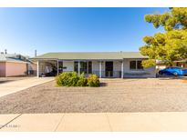 Ranch style home with carport and mature landscaping at 12216 N 107Th Ave, Sun City, AZ 85351