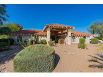 Front view of a single story home with a covered entryway and desert landscaping at 13108 N 76Th St, Scottsdale, AZ 85260