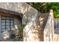Exterior stairs leading to condo entrance, surrounded by landscaping at 1449 E Highland Ave # 36, Phoenix, AZ 85014