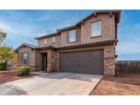 Two-story house with stone accents and a large garage at 4102 S 186Th Ave, Goodyear, AZ 85338