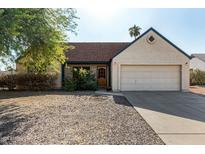 Single-story home with a two-car garage and landscaped yard at 7015 W Cherry Hills Dr, Peoria, AZ 85345