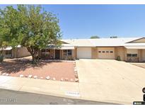 House exterior with driveway and desert landscaping at 9616 W Mountain View Rd # A, Peoria, AZ 85345
