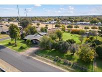 Aerial view of a ranch-style house with a large grassy yard and mature trees at 2975 E Campbell Rd, Gilbert, AZ 85234