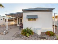 White mobile home with covered patio and landscaping at 44 S Hawes Rd # A15, Mesa, AZ 85208