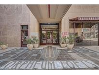 The building's entrance features a grand design with ornate tile work and potted plants at 114 W Adams St # 506, Phoenix, AZ 85003