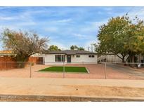 Newly renovated home with artificial turf lawn and modern facade at 15 N Ashland St, Mesa, AZ 85203