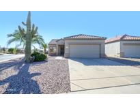 Single-story home with a two-car garage and desert landscaping at 16115 W Acacia Ct, Surprise, AZ 85374