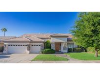 Single-story home with stone accents, a three-car garage, and a manicured lawn at 3760 S Vista Pl, Chandler, AZ 85248