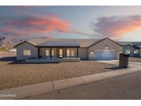 Single-story home with a modern design, covered porch, and two-car garage at 3877 S Veronica Ln, Gold Canyon, AZ 85118